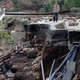 A man walks at a damaged area by earthquakes in Minamiaso, Kumamoto prefecture, Japan, Sunday, April 17, 2016. Two nights of increasingly terrifying earthquakes flattened houses and triggered major landslides in southern Japan. Photo credit AP